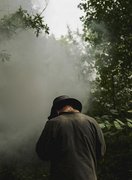 Volunteer photographed at a charcoal burn, Kenley Common, 2025
