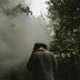 Volunteer photographed at a charcoal burn, Kenley Common, 2025